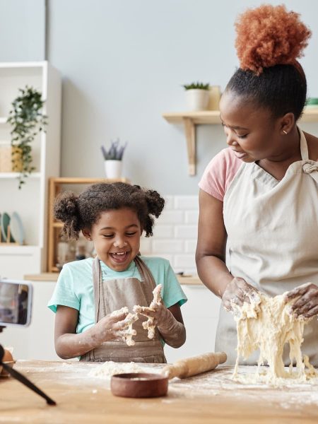 Happy mother and daughter baking together.
